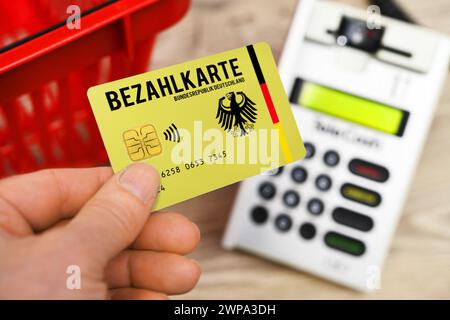 FOTOMONTAGE, Bezahlkarte für Geflüchtete und Asylsuchende vor einem Kartenlesegerät, Symbolfoto *** PHOTOMONTAGE, payment card for refugees and asylum seekers in front of a card reader, symbolic photo Stock Photo