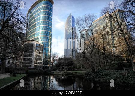 Wide -angle evening shot on a modern futuristic city scape with skyscrapers in the Brussels North business center from Botanical garden Stock Photo