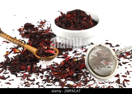 Dry hibiscus tea and sieve on white background. Selective Focus Stock Photo
