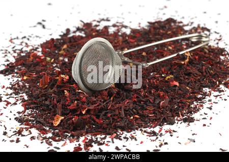 Dry hibiscus tea and sieve on white background. Selective Focus Stock Photo