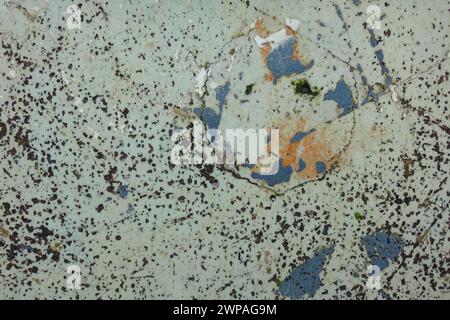 Gray scratched wall with remains of orange and grey paint Stock Photo