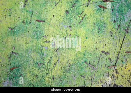 Scratched yellow and green painted grey wall. Colorful background Stock Photo