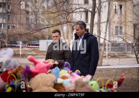 Odessa, Ukraine. 06th Mar, 2024. Ukrainian President Volodymyr Zelenskyy and Greek Prime Minister Kyriakos Mitsotakis honor the civilians killed by a Russian Shahed drone strike on a residential building, March 6, 2024 in Odesa, Ukraine. Later in the day another drone struck only 500 feet from the presidential motorcade carrying both leaders. Credit: Ukraine Presidency/Ukrainian Presidential Press Office/Alamy Live News Stock Photo