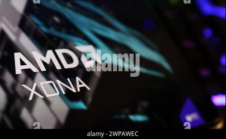 Viersen, Germany - March 1. 2024: Closeup of smartphone screen with logo lettering of AMD XDNA neural NPU CPU processor on computer keyboard Stock Photo