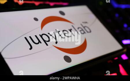 Viersen, Germany - March 1. 2024: Closeup of smartphone screen with logo lettering of Jupyter Lab on computer keyboard Stock Photo