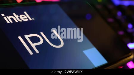 Viersen, Germany - March 1. 2024: Closeup of smartphone screen with logo lettering of Intel IPU on computer keyboard Stock Photo