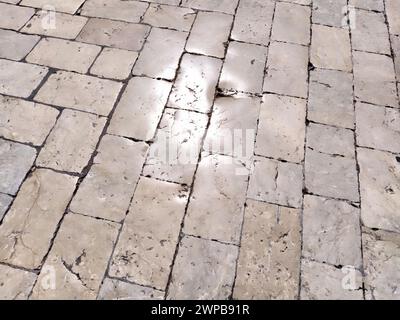 Marble floor on the street, Dubrovnik, Croatia. Antique masonry tiles rectangular blocks. Metamorphic rock composed of calcite CaCO3 mixed with other Stock Photo