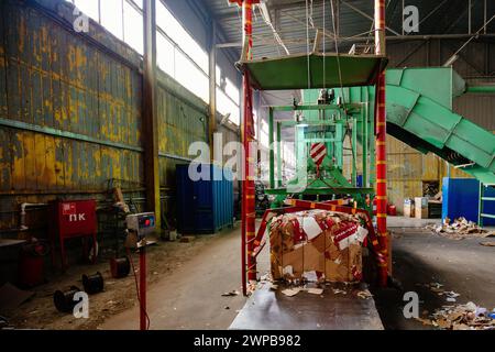 Pressing and baling of wastepaper in recycling factory. Stock Photo
