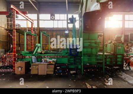 Pressing and packing of wastepaper in recycling factory. Stock Photo