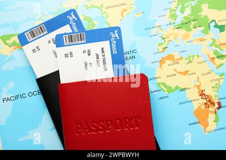 Honeymoon concept. Plane tickets and passports on world map, top view Stock Photo