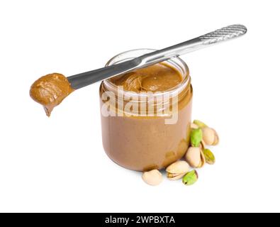 Tasty nut paste in jar, knife and pistachios isolated on white Stock Photo