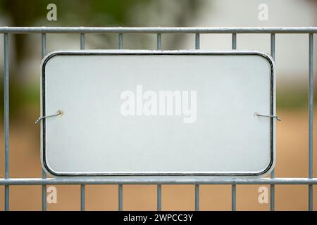 White unmarked sign on a fence with space for text Stock Photo