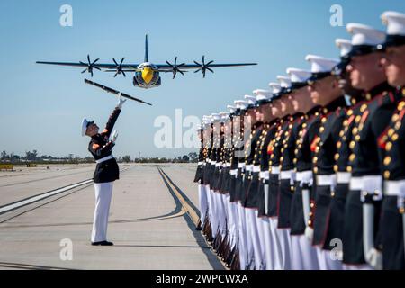 Yuma, Arizona, USA. 13th Feb, 2024. The U.S. Marine Corps Silent Drill Platoon performs as Fat Albert, the C-130J Super Hercules from the U.S. Navy Blue Angels, flies over at Marine Corps Air Station Yuma, Arizona. The Marines of this 24-Marine platoon represent the highest standard of excellence and precision, as well as the men and women who have made sacrifices for their country. (Credit Image: © Cody Deccio/U.S. Navy/ZUMA Press Wire) EDITORIAL USAGE ONLY! Not for Commercial USAGE! Stock Photo