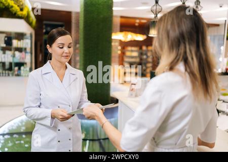 Team of doctors working together on patients file at hospital. Medical staff analyzing report and working at clinic. Female doctor having discussion Stock Photo