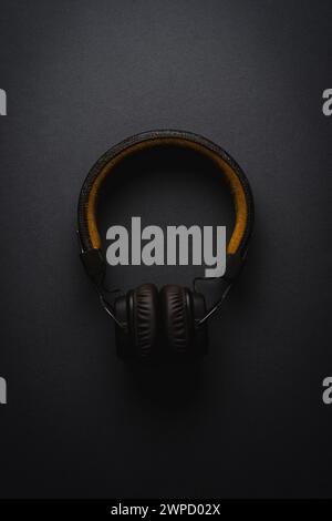 Retro style wireless over-ear headphones on dark gray background Stock Photo
