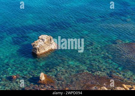Elevated view of the sea with turquoise and clean water and some rocks Stock Photo