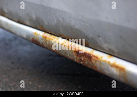 Rusty threshold of a grey old car close up Stock Photo