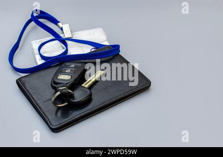 Wallet, car keys, lying on the table together, as if someone is about to leave or just arrived. Stock Photo