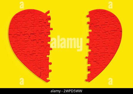 Close-up of a split red heart-shaped jigsaw puzzle isolated on a bold yellow background. Love and romance related concept. Stock Photo
