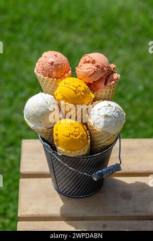 Assorted ice cream flavours in delightful waffle cones, a treat for every taste bud. Outdoor Stock Photo