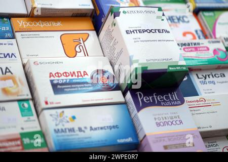 KYIV, UKRAINE - NOVEMBER 27, 2023 Many boxes of pills and capsules stacked in pharmacy drug store close up Stock Photo