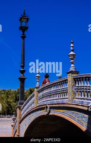 A woman enjoying the day on the Plaza España bridge in Seville. Stock Photo