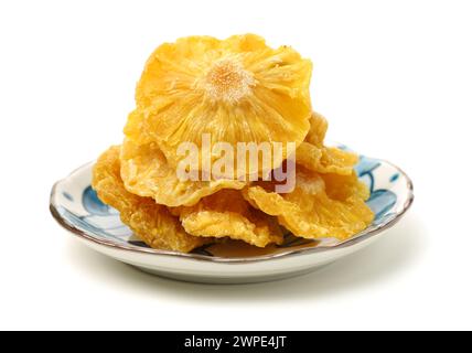 Dried pineapple rings on white background Stock Photo