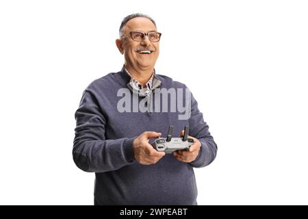 Happy mature man holding a drone remote cotroller isolated on white background Stock Photo