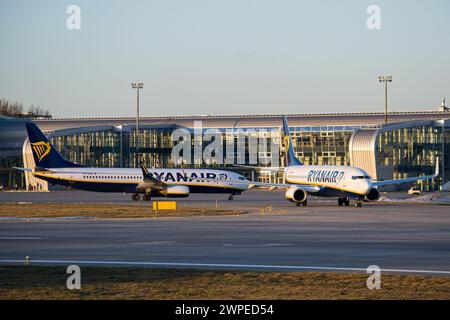 Two Irish low-cost airline's Ryanair Boeing 737-800s taxiing in Lviv during golden hour Stock Photo