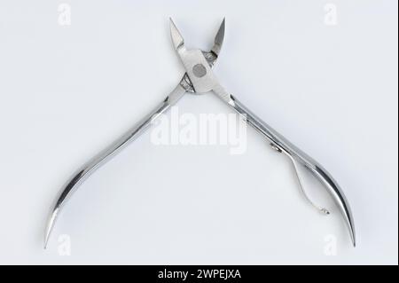 Open nail foot clippers scissors close up view isolated on studio background Stock Photo