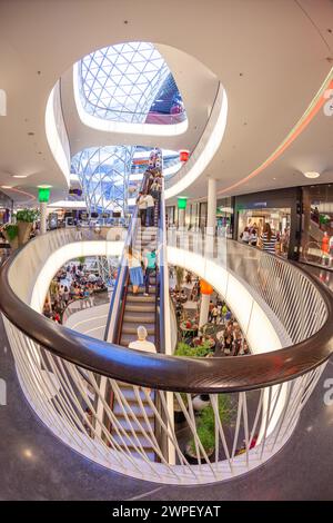 Frankfurt, Germany - April 23, 2011: interior view of atrium and escalator hall with  curvature corridor of Myzeil, modern shopping mall in Frankfurt. Stock Photo