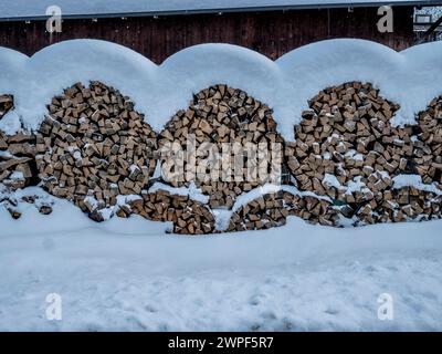 This symmetrical snow image of a traditional wood pile is in the Obernbergtal valley near the town of Steinach am Brenner in the Austrian Tirol Stock Photo