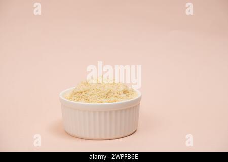 Almond flour in a plate on a beige background, place for text Stock Photo