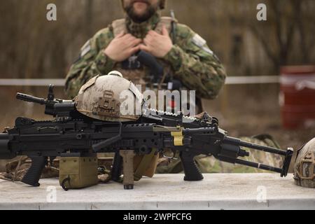 airsoft replica weapon and top camouflage helmet AOR 1, machine gun on a natural background Stock Photo