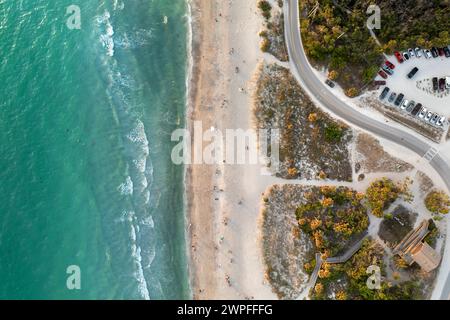 Vehicle parking area with cars parked on ocean beach parking lot at sunset. Summer vacation on beachfront in Southern Florida Stock Photo