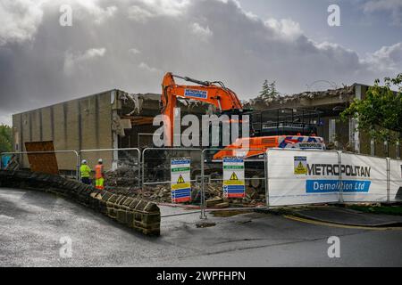 Demolition site (rubble, heavy machinery, building deconstruction, controlled collapse, empty shell) - Baildon library, West Yorkshire, England, UK. Stock Photo