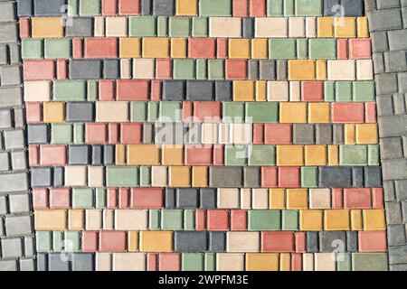 Colorful pavement on sunny day in public park. Colorful paving stones in urban park landscaping design as background Stock Photo