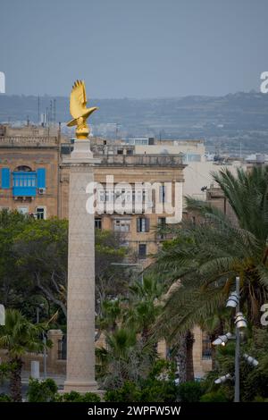 A golden eagle sculpture on a high column in Valetta, Malta. Stock Photo