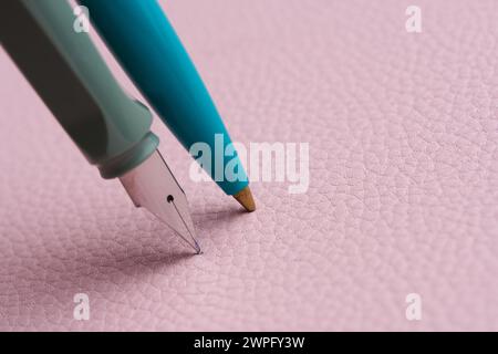 Fountain and ballpoint pens on a pink background Stock Photo