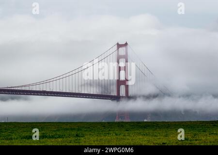 The Golden Gate Bridge in San Francisco, California,USA linking Marin County and San Fransisco over the bay with dramatic dense fog Stock Photo