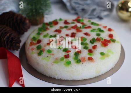 Vattayappam with tutti fruity, a Kerala sweet dish. Vattayappam is a steamed rice cake with coconut and yeast. Tutti fruity are candied fruits. Shot o Stock Photo