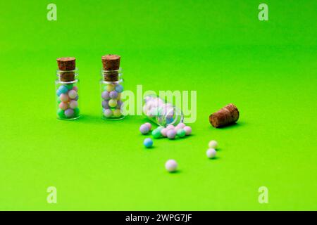 Three glass jars with colorful spheres where one of them is open Stock Photo