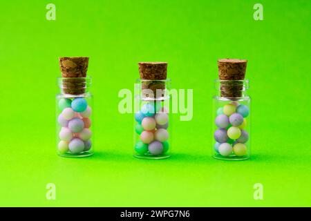 Three glass jars with colorful spheres Stock Photo