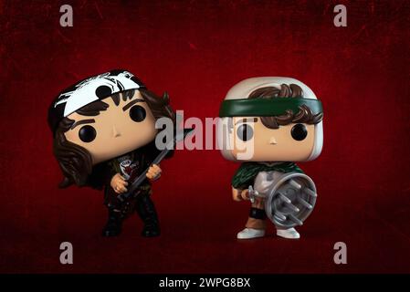 Funko POP vinyl figures of Eddie Munson and Dustin Henderson characters of the TV series Stranger Things over red background. Illustrative editorial o Stock Photo