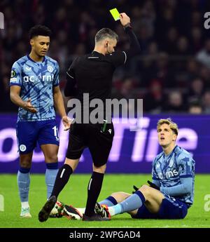 AMSTERDAM - Nicolo Zaniolo of Aston Villa FC receives the yellow card from referee Enea Jorgji during the UEFA Conference League round of 16 match between Ajax Amsterdam and Aston Villa FC at the Johan Cruijff ArenA on March 7, 2024 in Amsterdam, Netherlands. ANP OLAF KRAAK Stock Photo