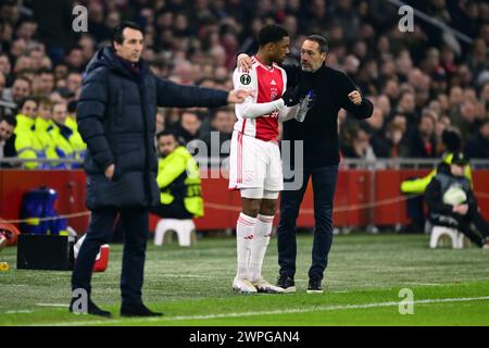 AMSTERDAM - (l-r) Chuba Akpom of Ajax, Ajax coach John van't Schip during the UEFA Conference League eighth final match between Ajax Amsterdam and Aston Villa FC at the Johan Cruijff ArenA on March 7, 2024 in Amsterdam, Netherlands. ANP OLAF KRAAK Stock Photo