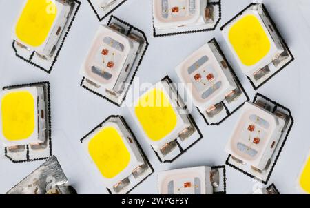 Closeup of light-emitting diodes on electronic LED circuit inside an electric household lamp on printed wiring board detail. Surface mount technology. Stock Photo