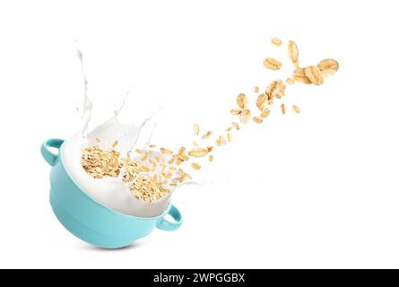 Pot with splashes of milk and flying rolled oats on white background Stock Photo