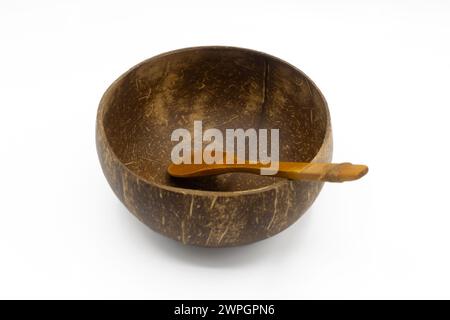 Coconut bowl and wooden spoon isolated on white background Stock Photo