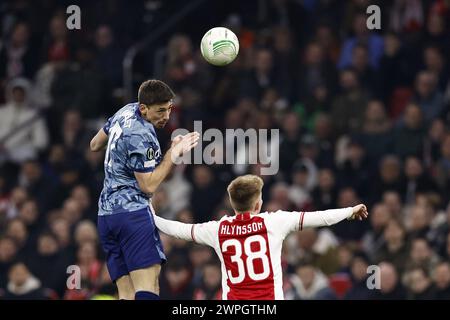 AMSTERDAM - (l-r) Clement Lenglet of Aston Villa FC, Kristian Hlynsson of Ajax during the UEFA Conference League round of 16 match between Ajax Amsterdam and Aston Villa FC at the Johan Cruijff ArenA on March 7, 2024 in Amsterdam, Netherlands. ANP | Hollandse Hoogte | MAURICE VAN STEEN Stock Photo